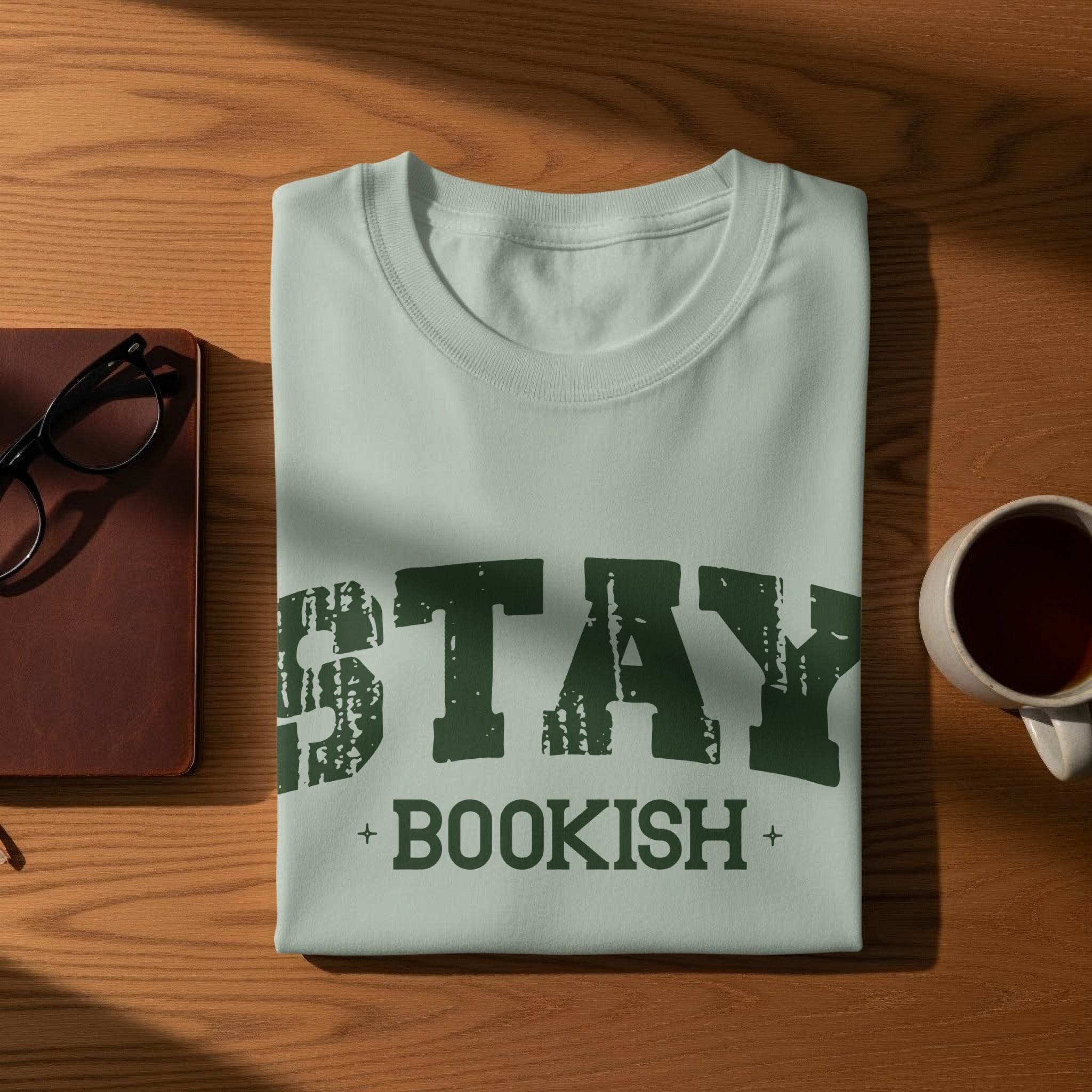 Light blue t-shirt featuring "STAY BOOKISH" text in distressed green font
