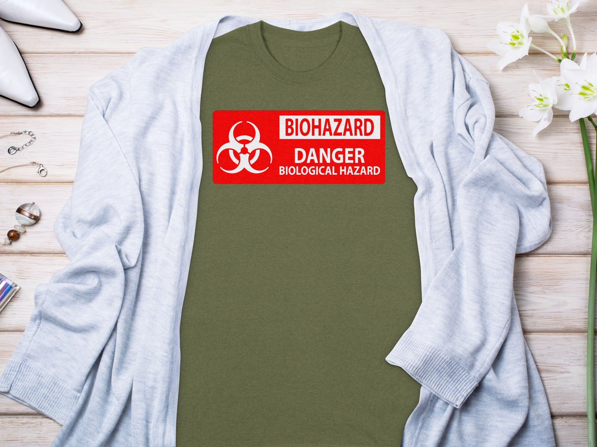 Olive green t-shirt with red biohazard danger biological hazard graphic.