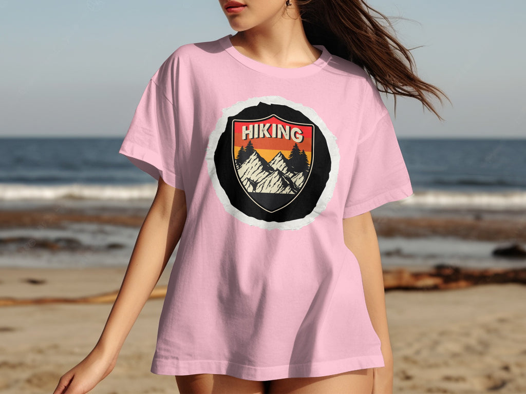 Pink t-shirt with a round "Hiking" mountain graphic on the front.