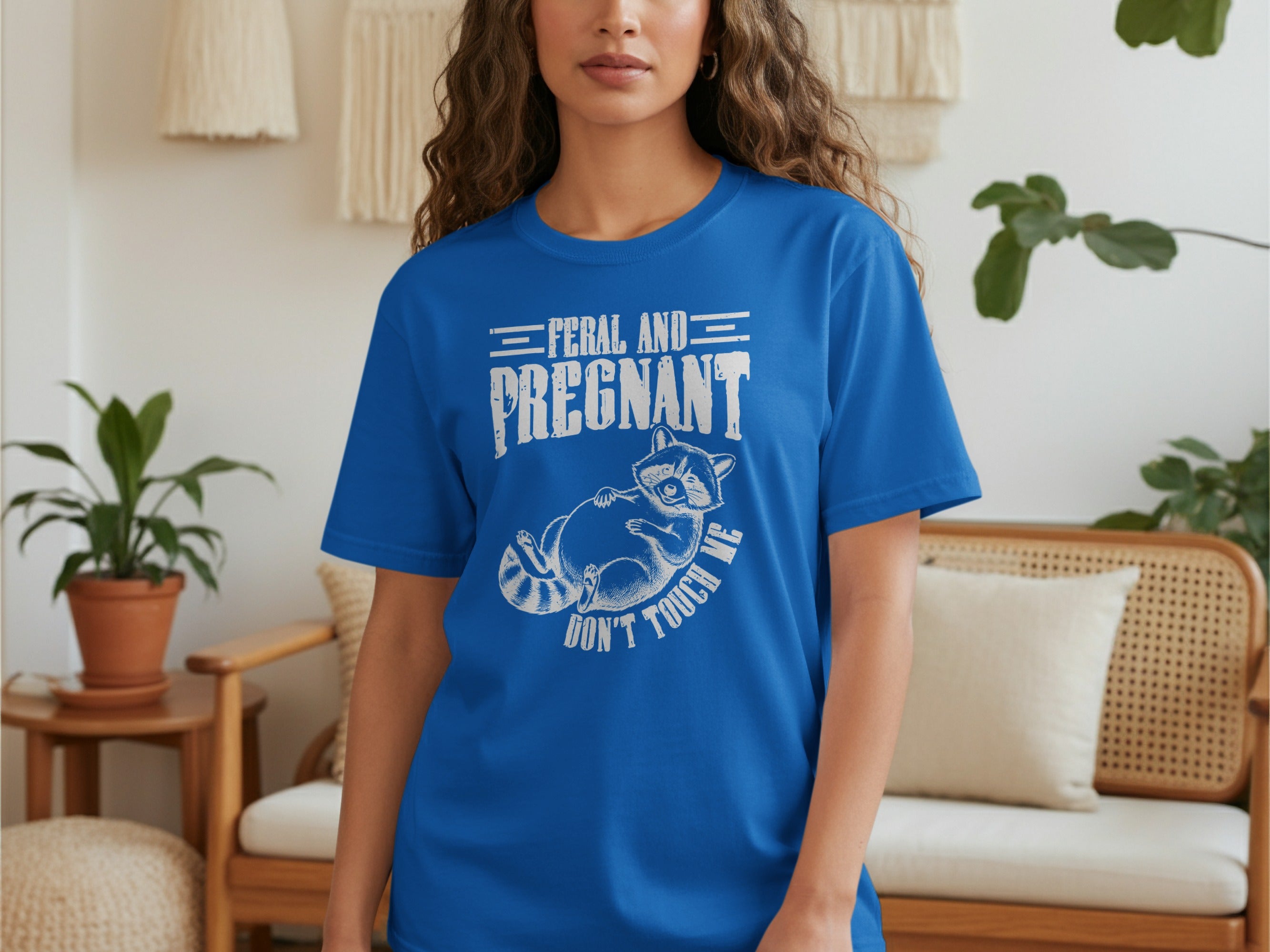 Blue t-shirt with "Feral and Pregnant. Don't Touch Me" and raccoon graphic.
