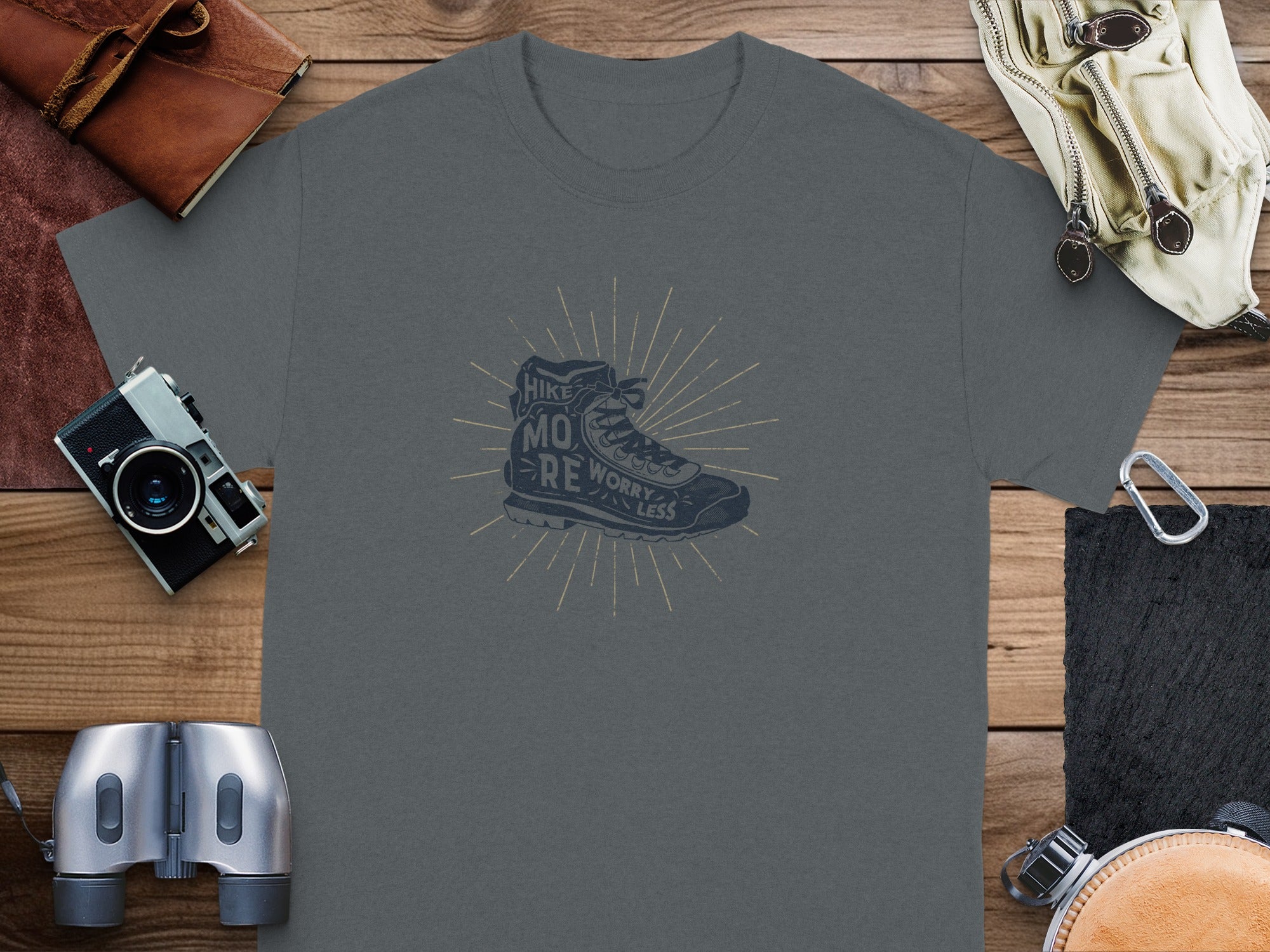 Dark grey t-shirt with graphic of boot and text "Hike More Worry Less".
