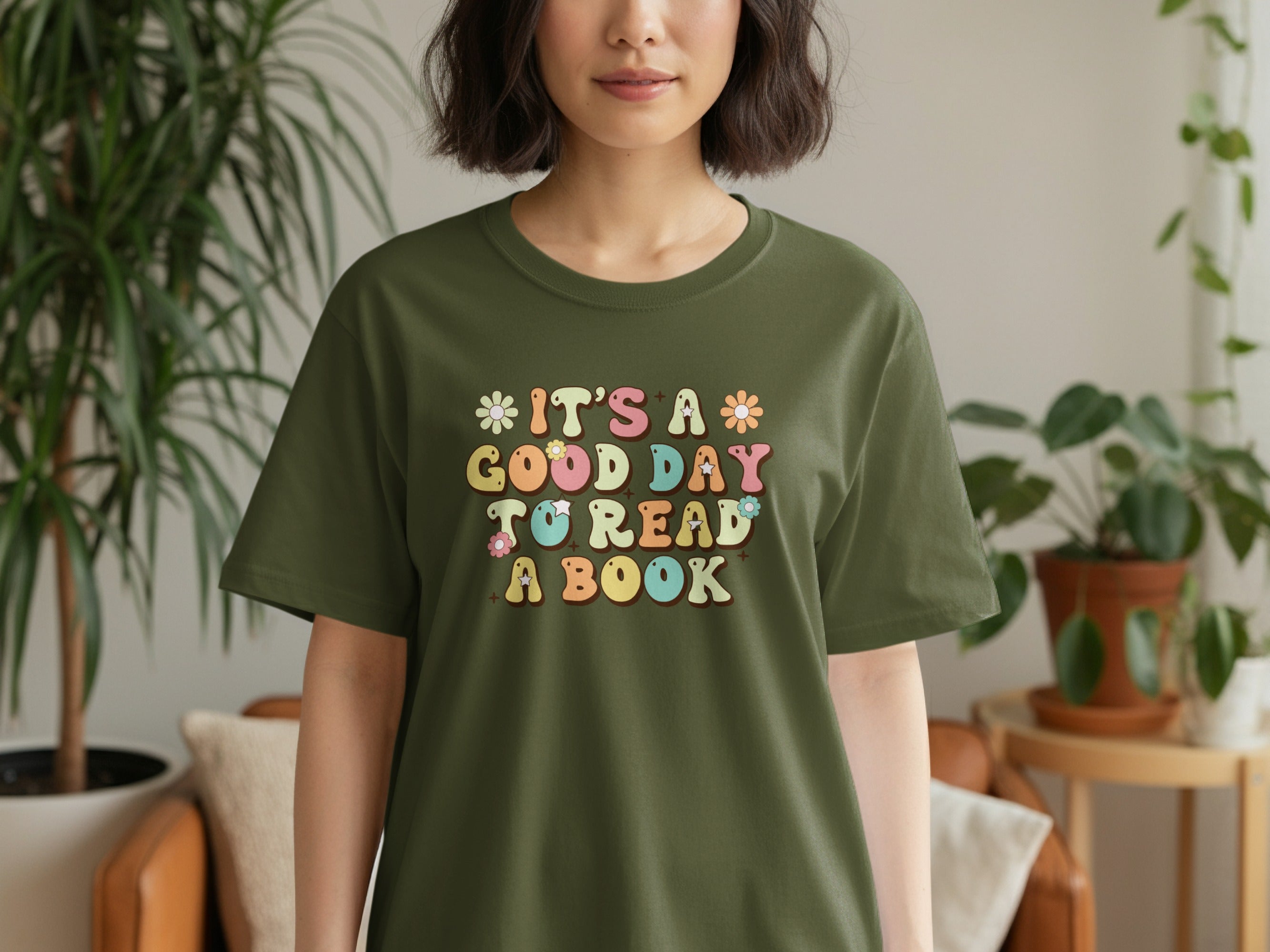 It's a good day to read a book graphic on a green t-shirt.