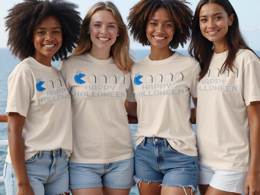 Four smiling women wear cream t-shirts with "Happy Halloween" and ghost graphics.
