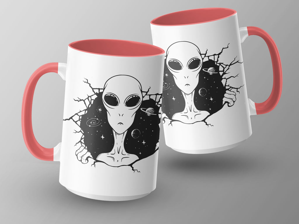 Two white mugs with red handles featuring black alien and starry space designs.