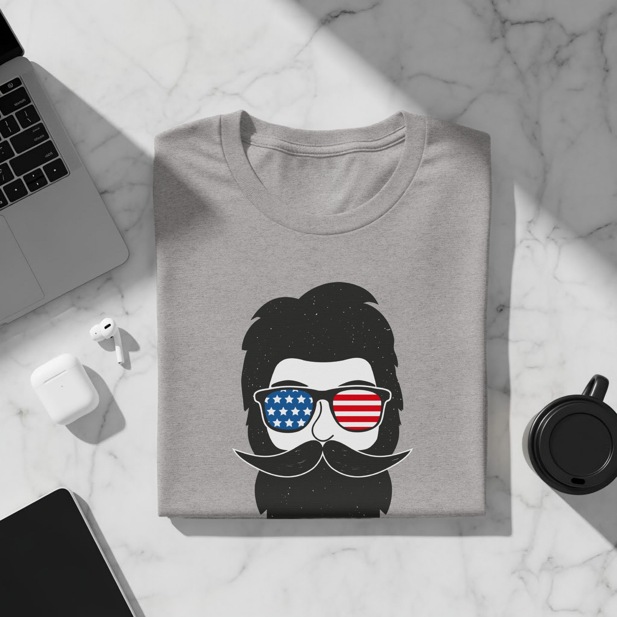 Gray t-shirt with a stylized black beard and mustache wearing American flag sunglasses.