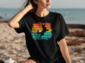 Black t-shirt with a jumping dog silhouette on retro stripes.