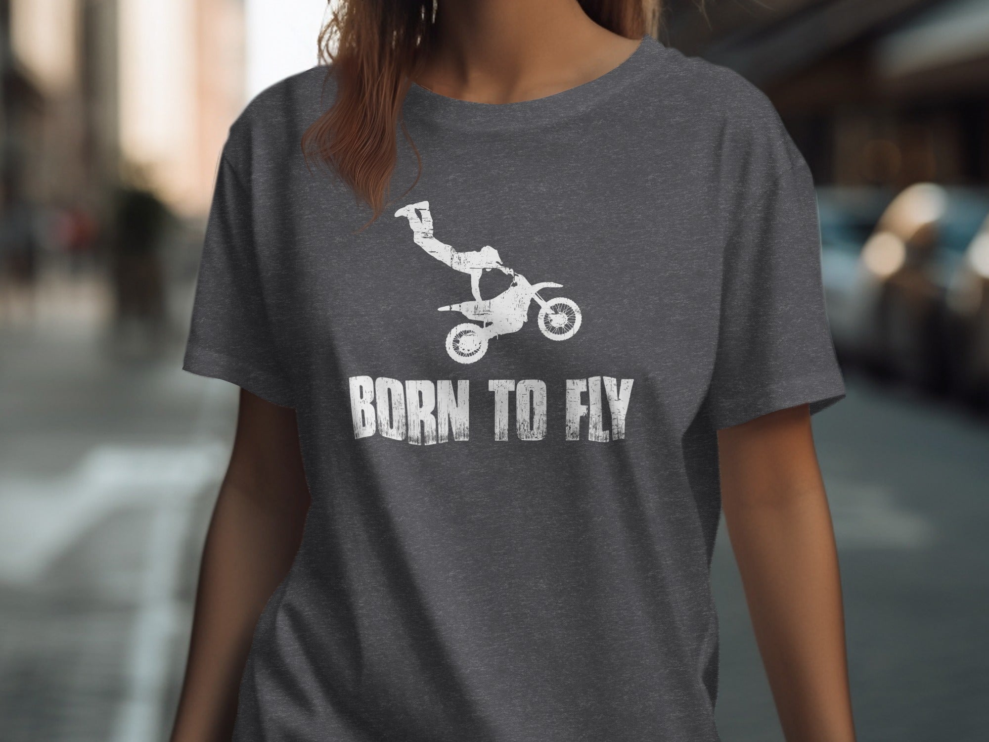 Dark gray t-shirt with white distressed graphic of a motocross rider and the text "BORN TO FLY".