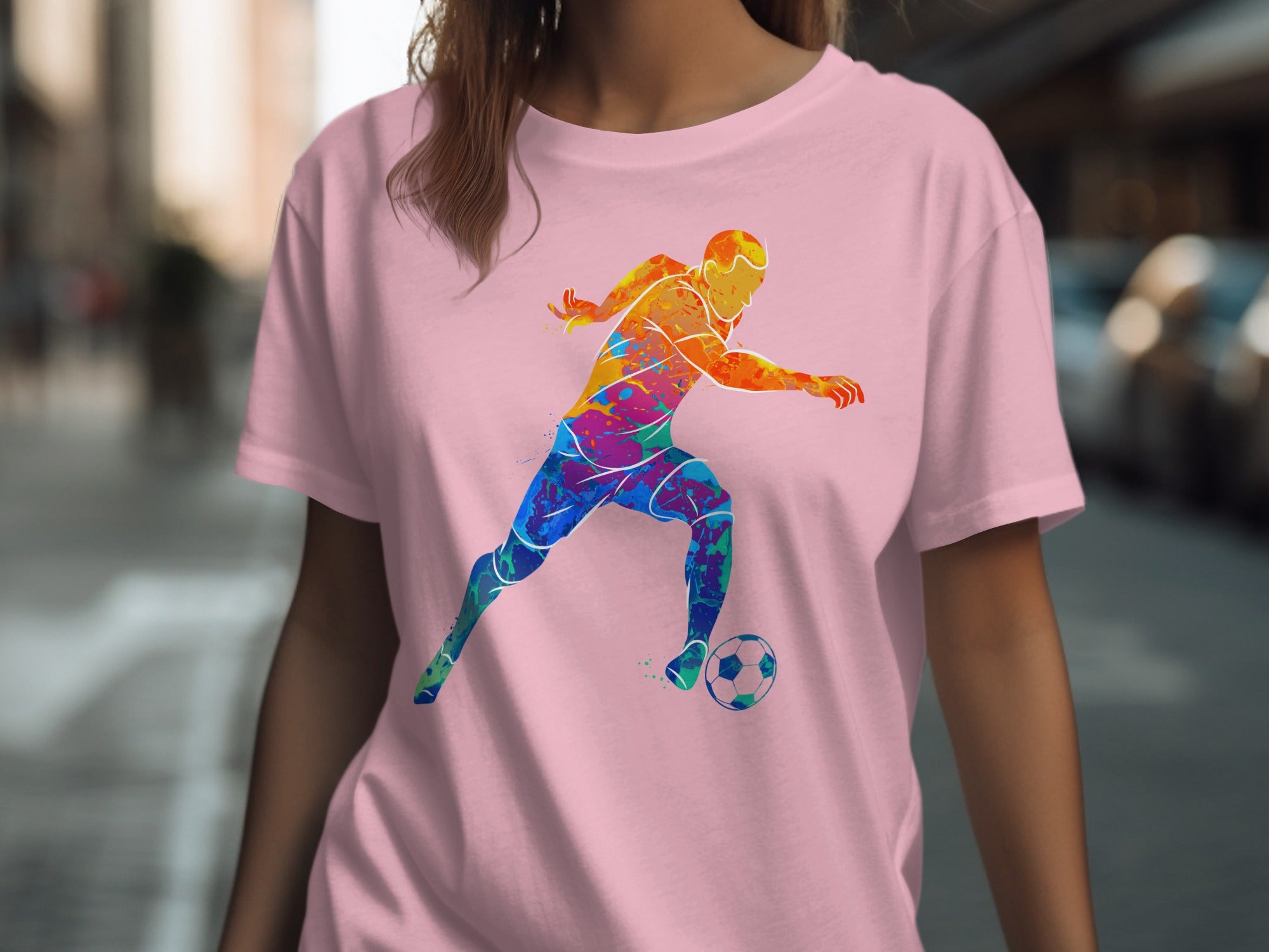 Pink t-shirt with a colorful, abstract soccer player graphic and a soccer ball.