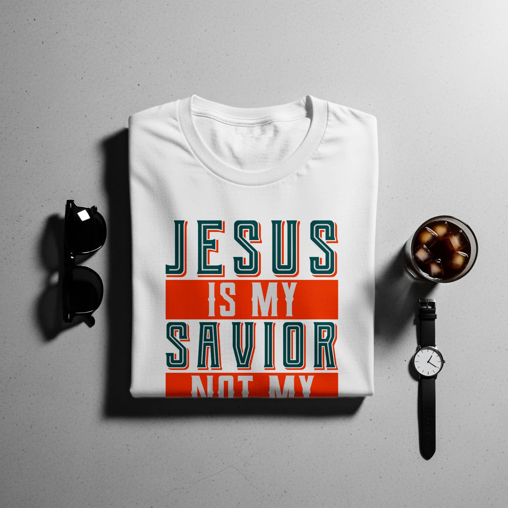 White t-shirt with "JESUS IS MY SAVIOR NOT MY" text on front.