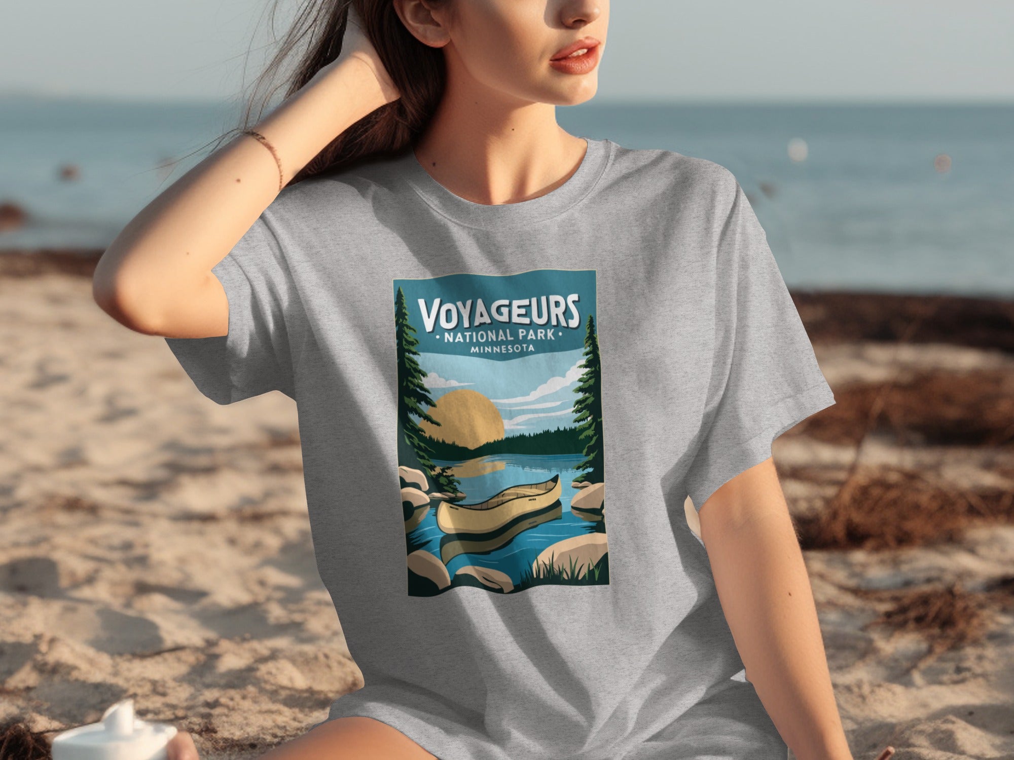 Voyageurs National Park Minnesota graphic on grey t-shirt with canoe and sunset scene.