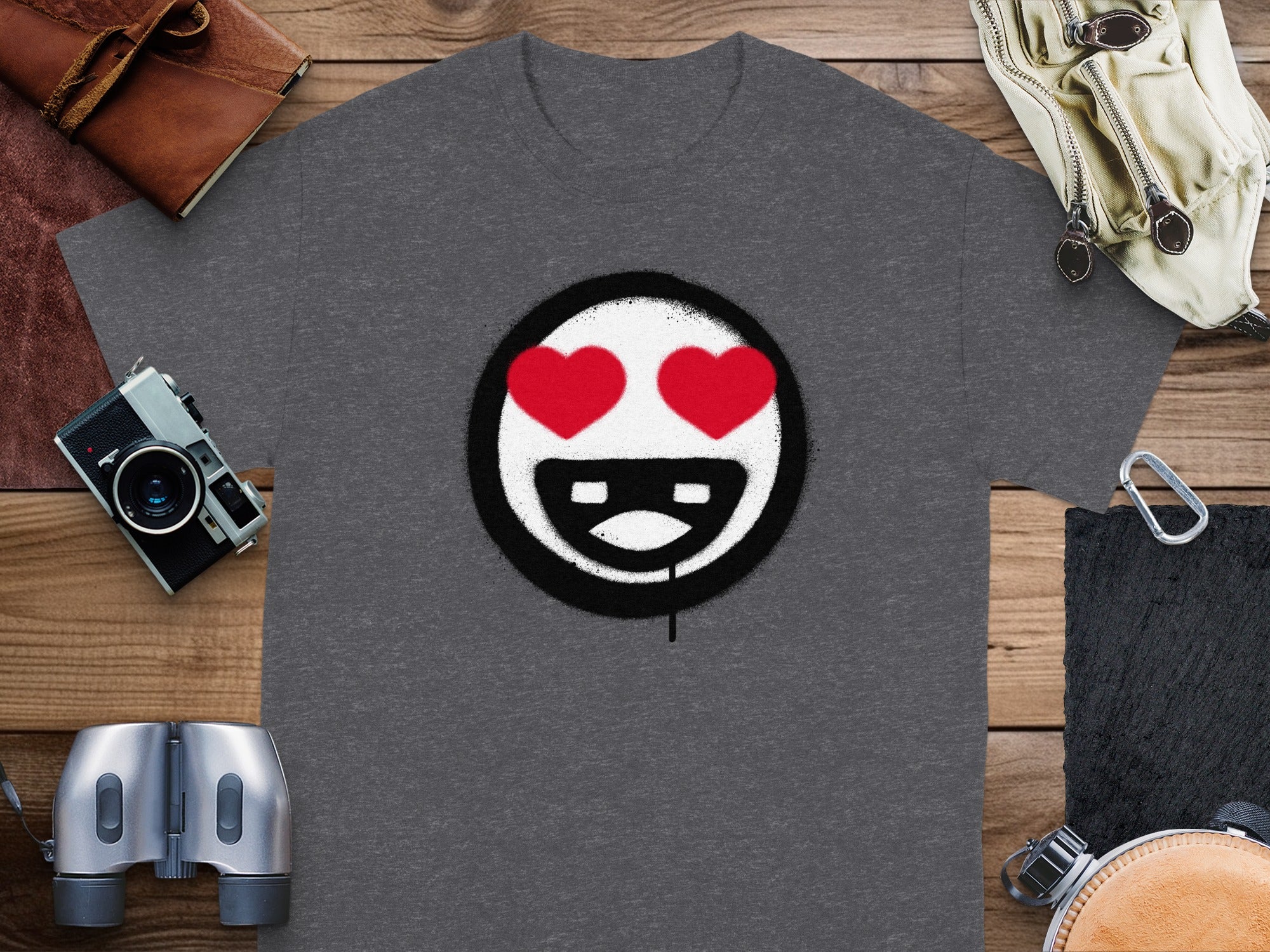 Dark grey t-shirt with a white smiley face, red heart eyes, and black spray paint outline.