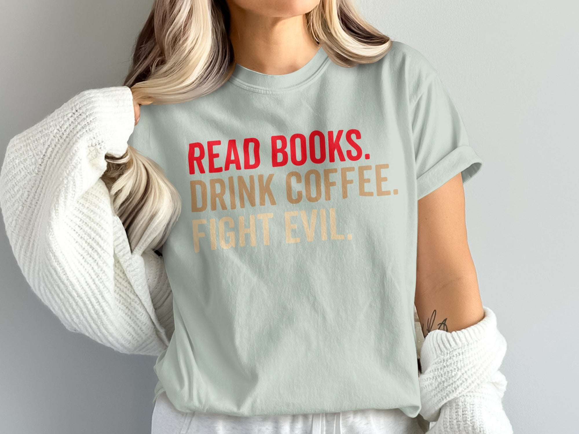 Light mint t-shirt with red, gold, and tan text: "READ BOOKS. DRINK COFFEE. FIGHT EVIL."
