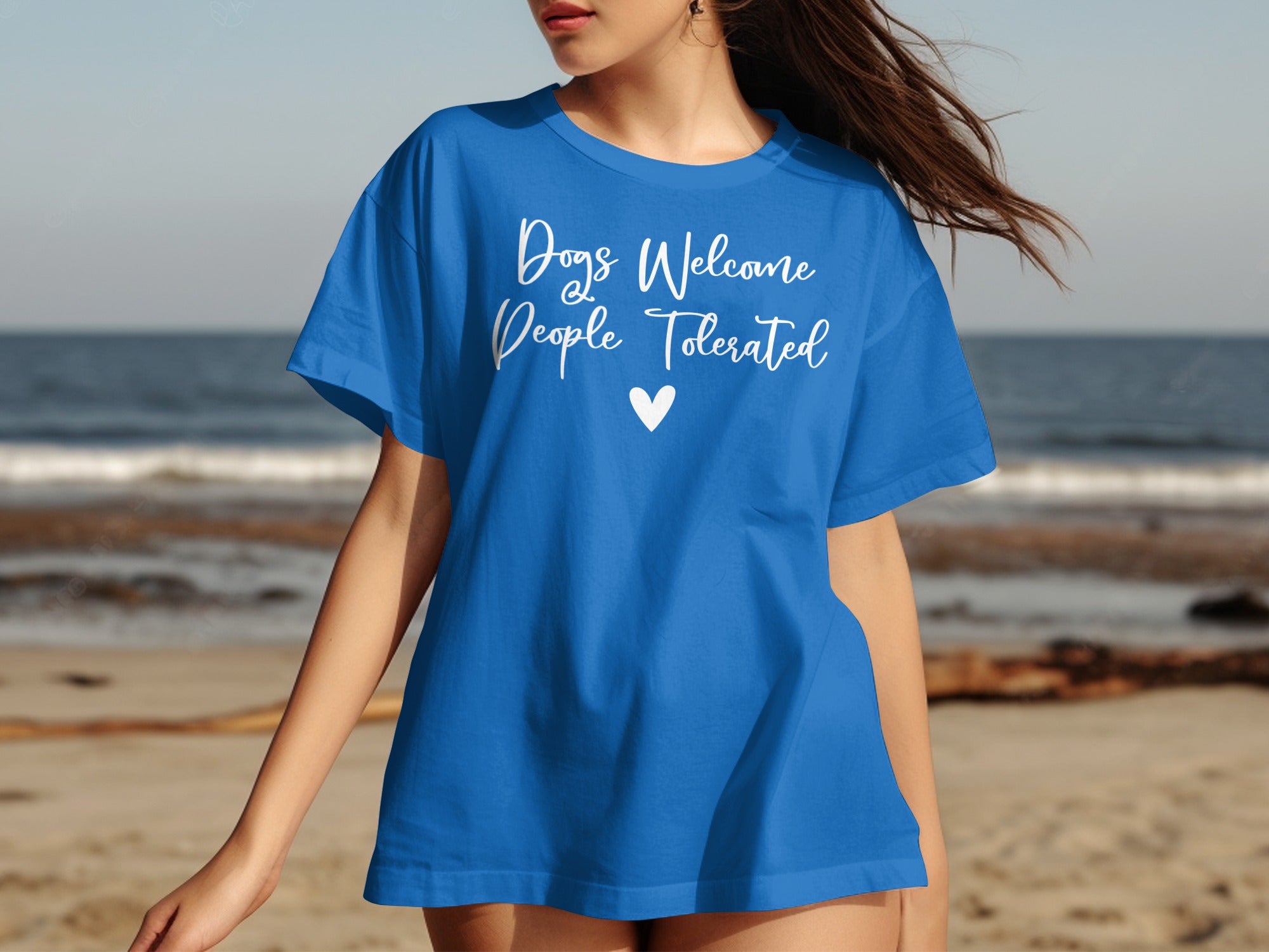 Blue t-shirt with white text "Dogs Welcome, People Tolerated" and a heart.