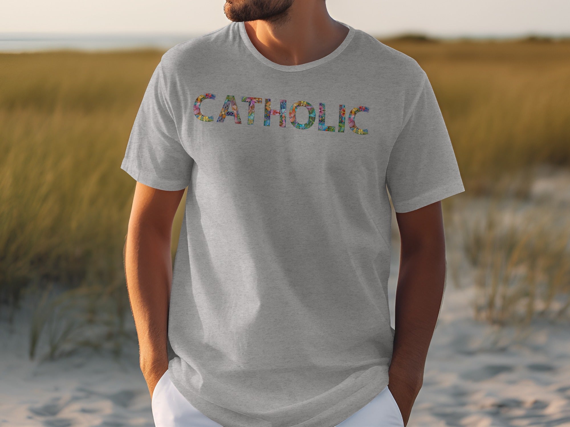 Grey t-shirt with colorful letters spelling CATHOLIC on chest.