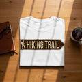 White t-shirt with a distressed arrow sign graphic reading "Hiking Trail".