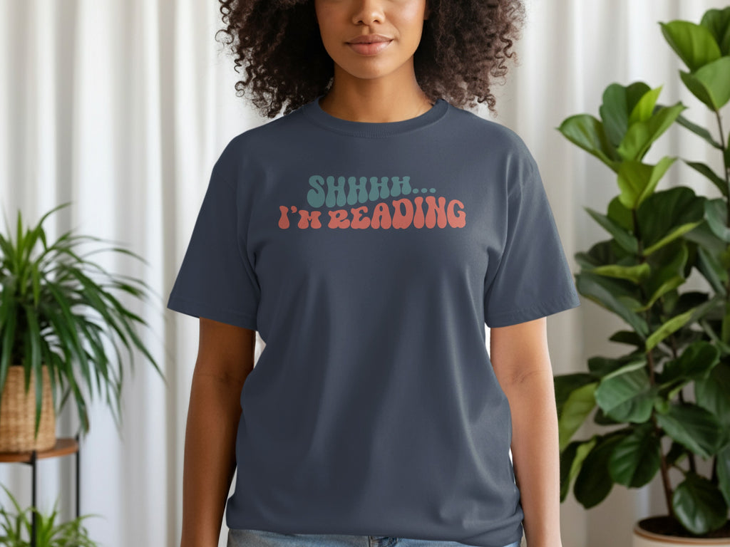 Dark grey t-shirt with text SHHHH... I'M READING in wavy font.