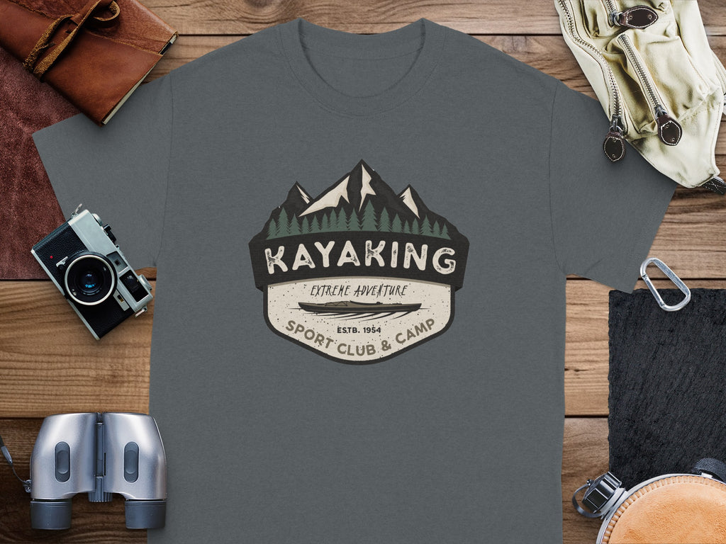 Dark grey t-shirt with a shield emblem featuring mountains, trees, and text for Kayaking Sport Club.