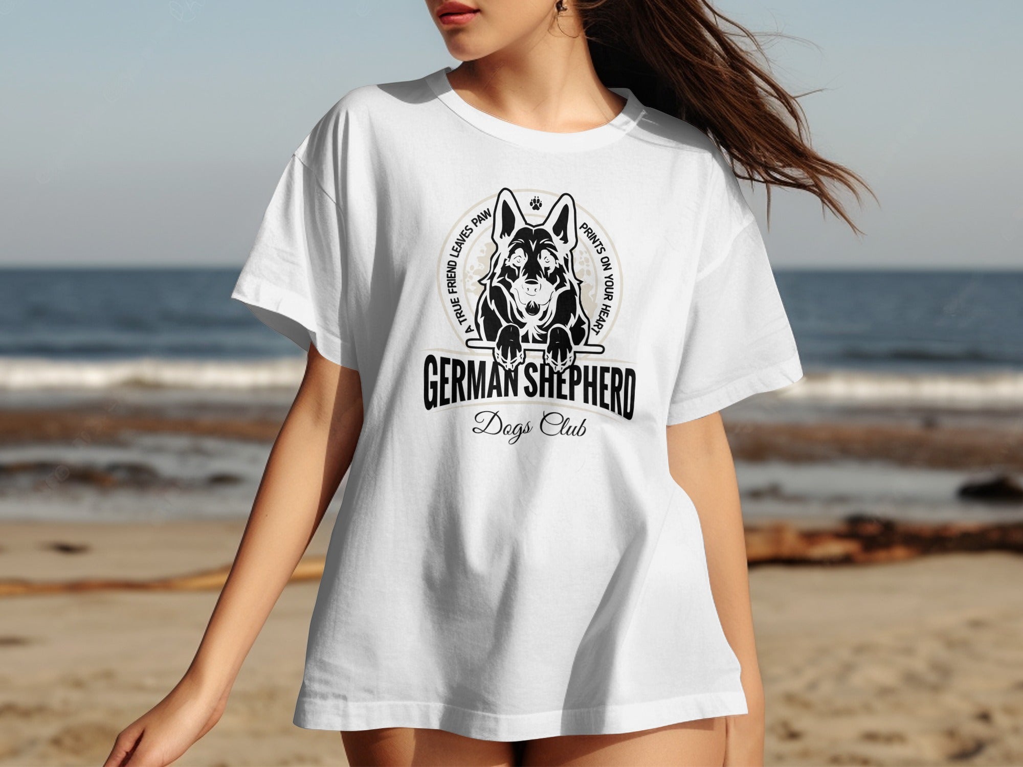 White t-shirt with German Shepherd Dogs Club graphic on a beach background.