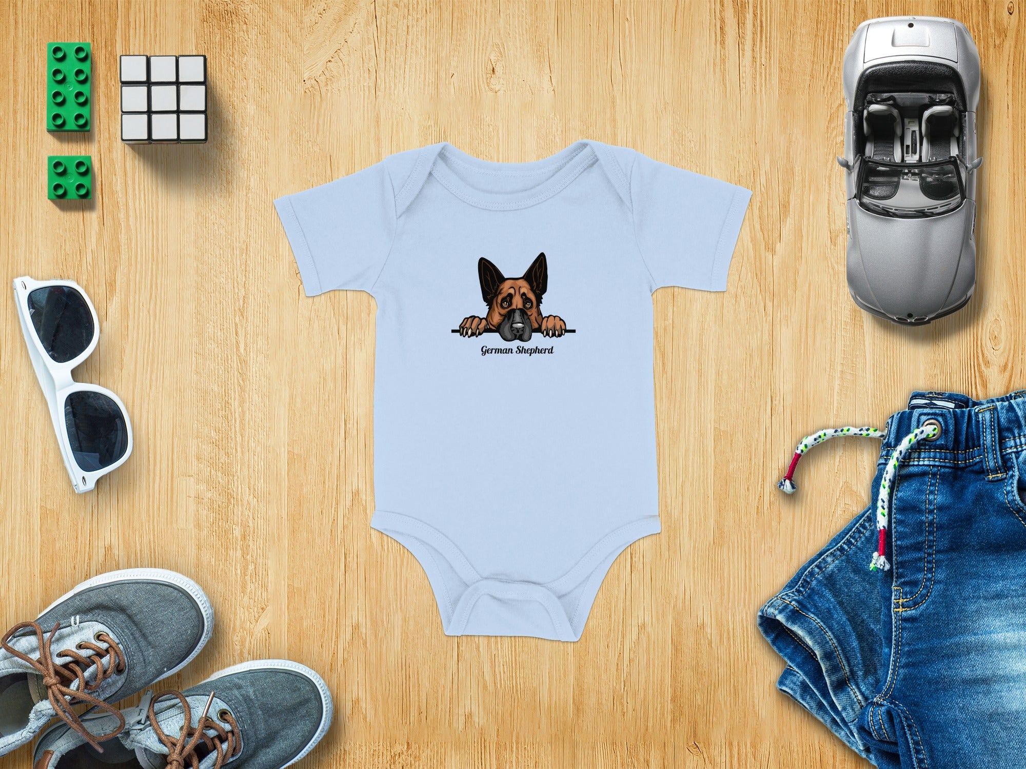 Light blue baby onesie with a German Shepherd graphic and text.