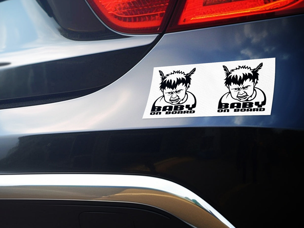 Two black and white stickers showing a cartoon baby with horns and "BABY ON BOARD" text.
