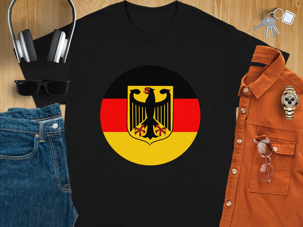 Black t-shirt with German flag emblem, sunglasses, headphones, jeans, and orange shirt.