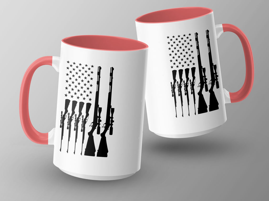 Two white mugs with coral handles and rims, featuring black American flag and rifle graphics.