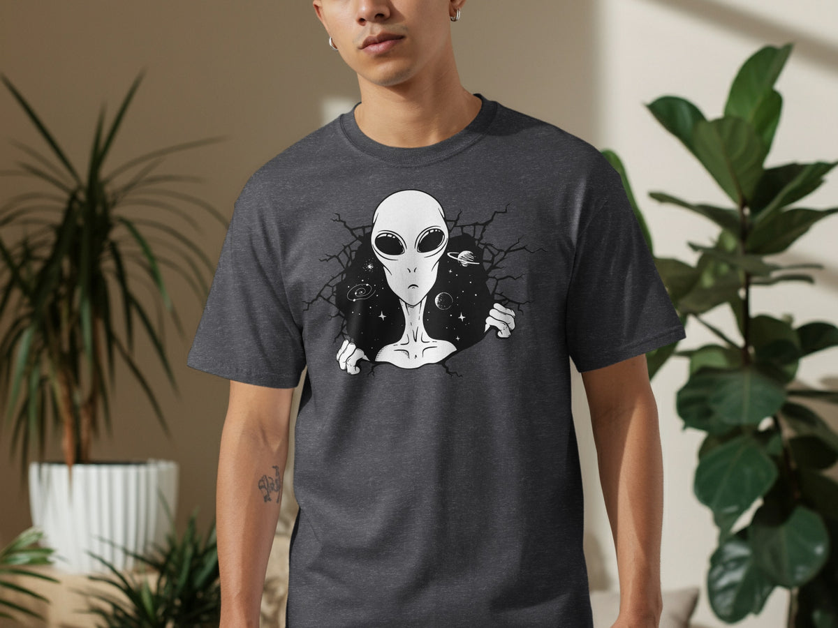Dark grey t-shirt with a black and white graphic of an alien peeking through a cracked void of space.