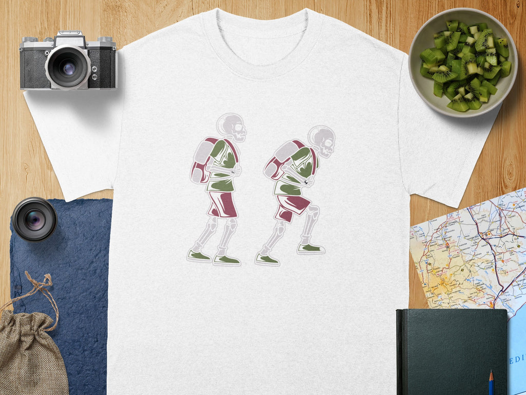 White t-shirt with two skeletons wearing backpacks and shorts, walking to the right.
