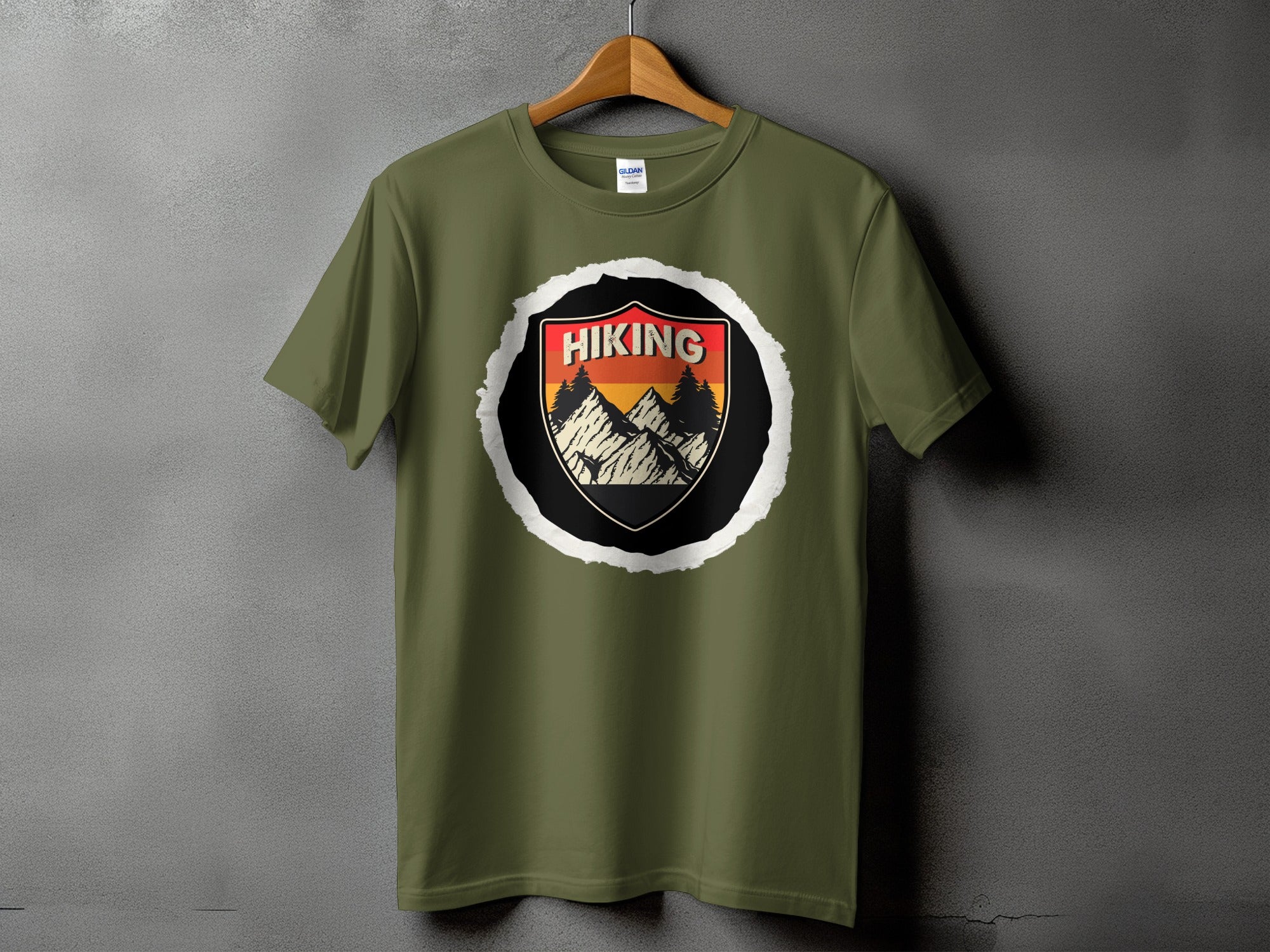 Green t-shirt with a circular hiking graphic featuring mountains and trees.