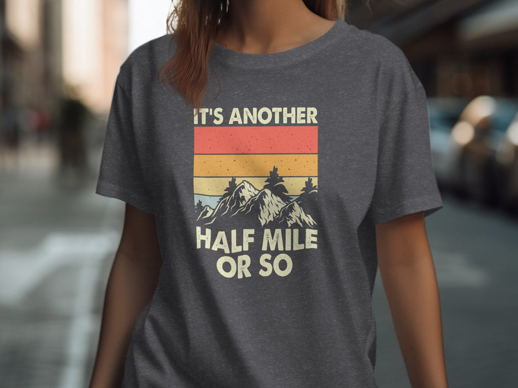 Dark gray t-shirt with vintage mountain graphic and text "IT'S ANOTHER HALF MILE OR SO".