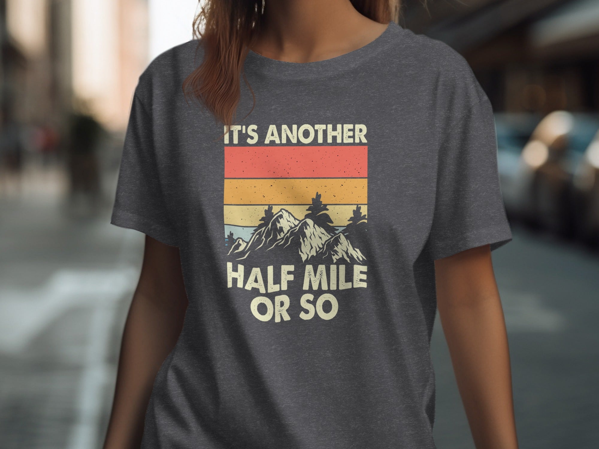 Dark gray t-shirt with vintage mountain graphic and text "IT'S ANOTHER HALF MILE OR SO".
