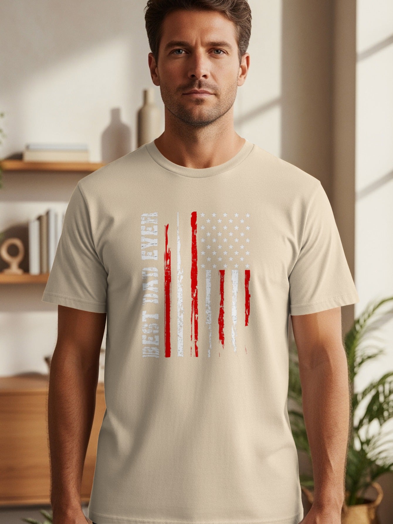 Man wearing a tan t-shirt with a distressed American flag graphic and text.
