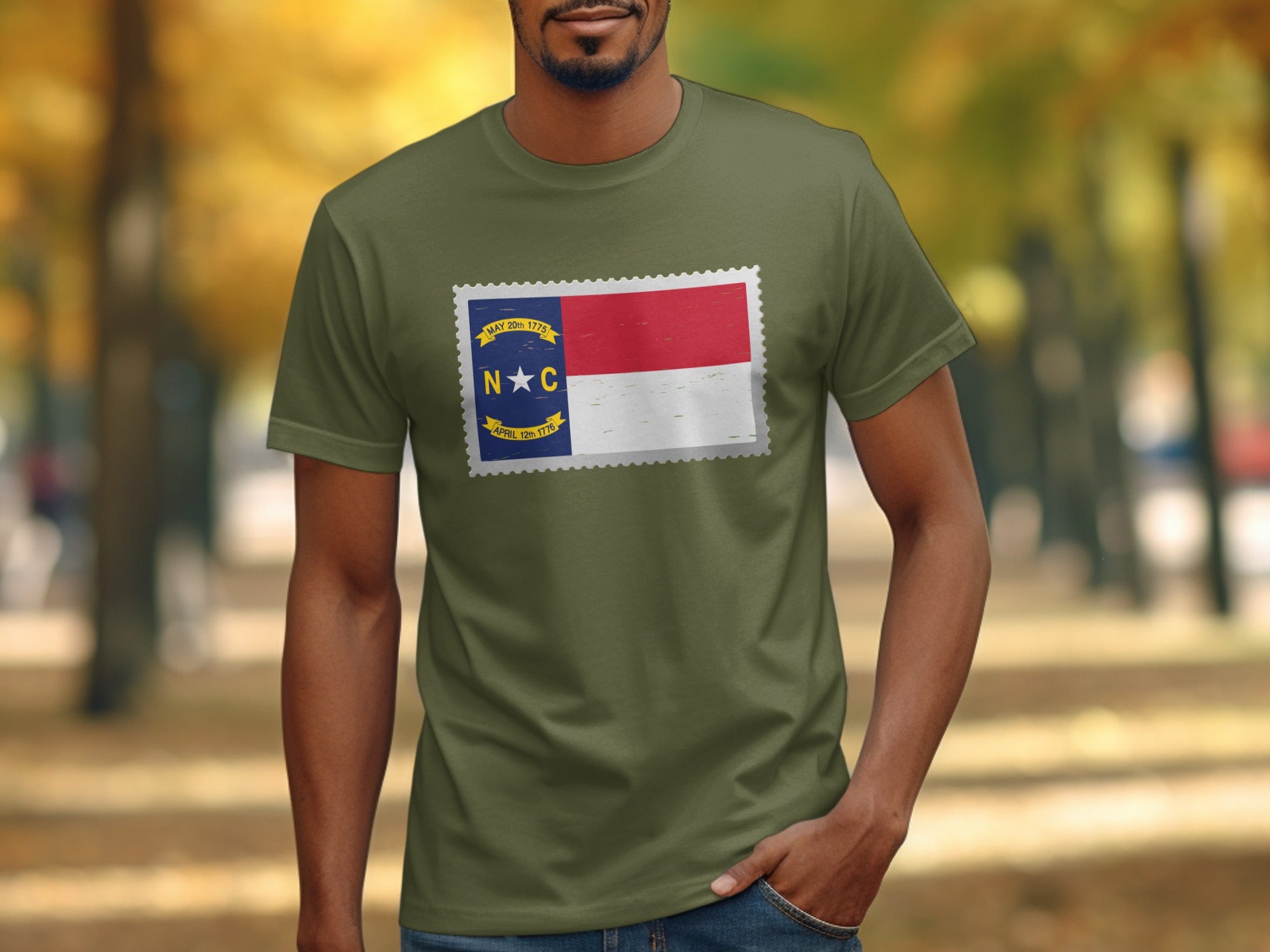 Green t-shirt with the North Carolina flag depicted as a postage stamp.