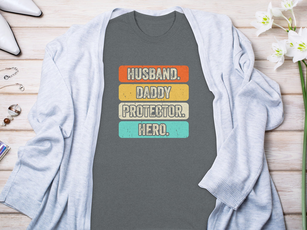 T-shirt with "Husband. Daddy. Protector. Hero." text in distressed retro stripes.