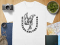 White t-shirt with black graphic of skeleton skull and text "WEEKENDS ARE FOR HIKING".