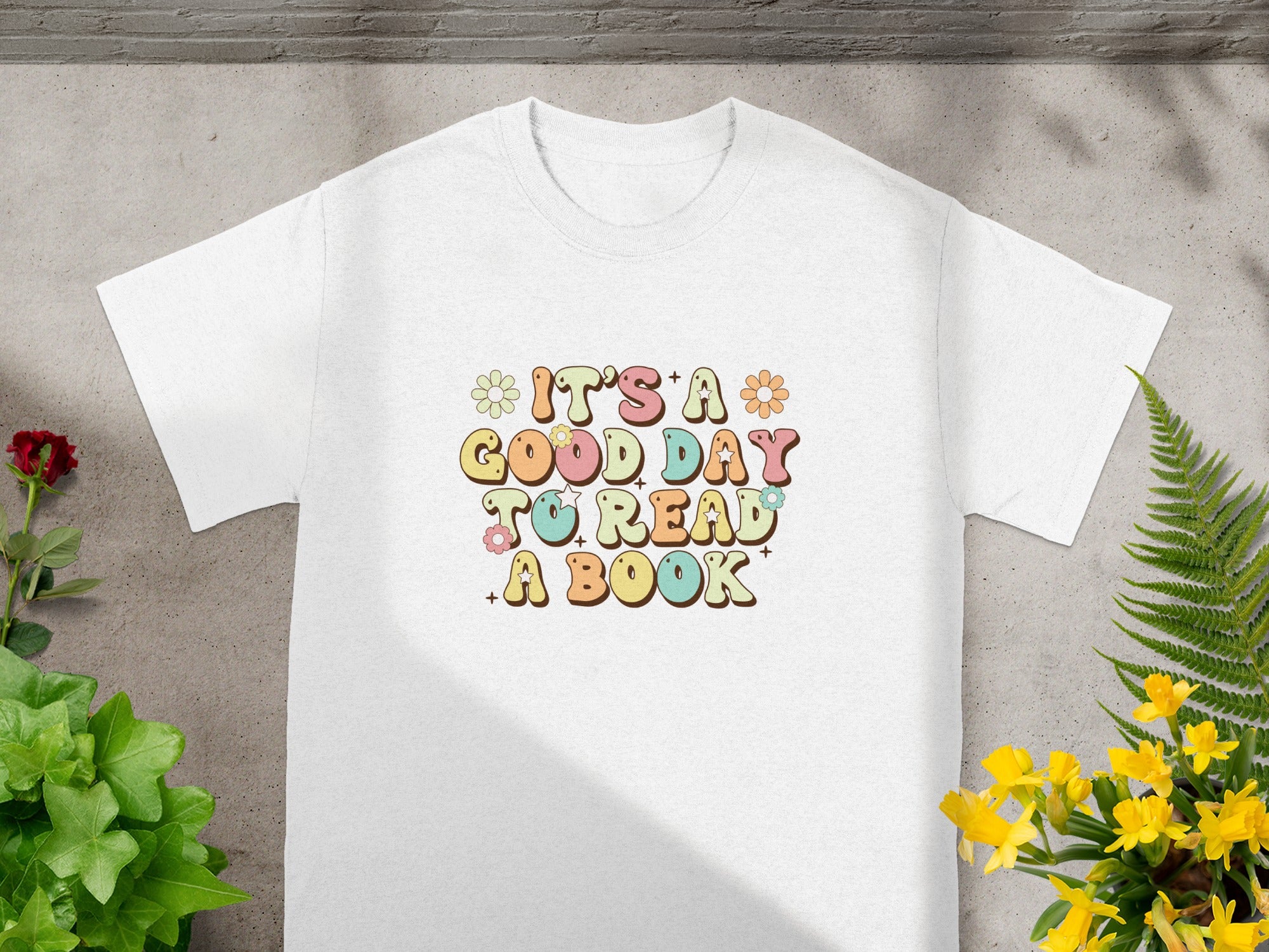White t-shirt with retro text: It's a Good Day to Read a Book.