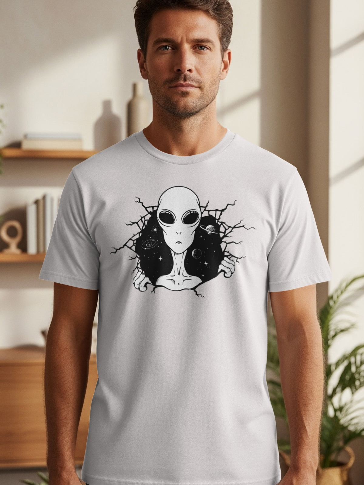 Gray t-shirt with a black alien bursting through a cracked space background.