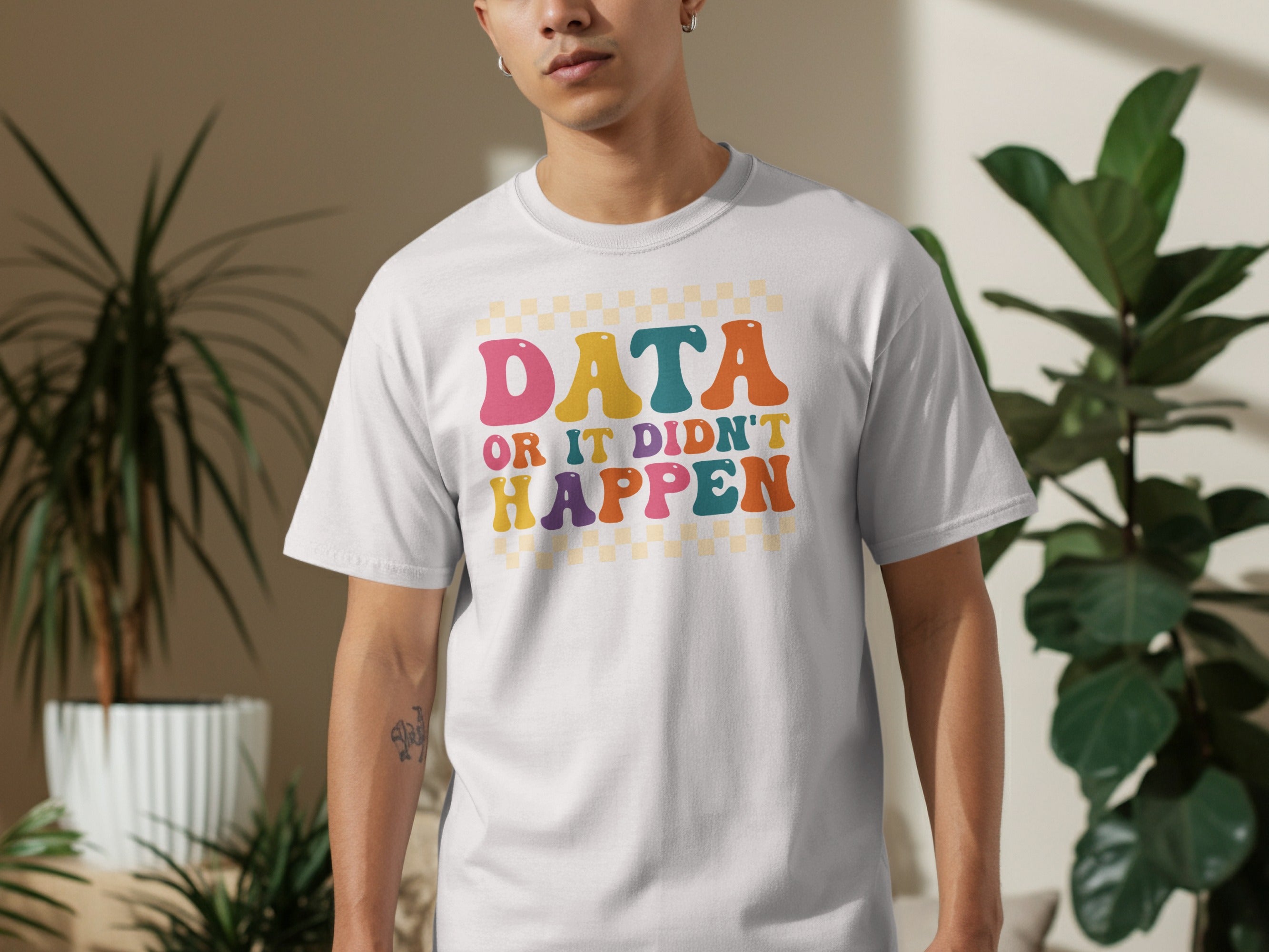 White t-shirt with text "DATA OR IT DIDN'T HAPPEN" in colorful retro font.