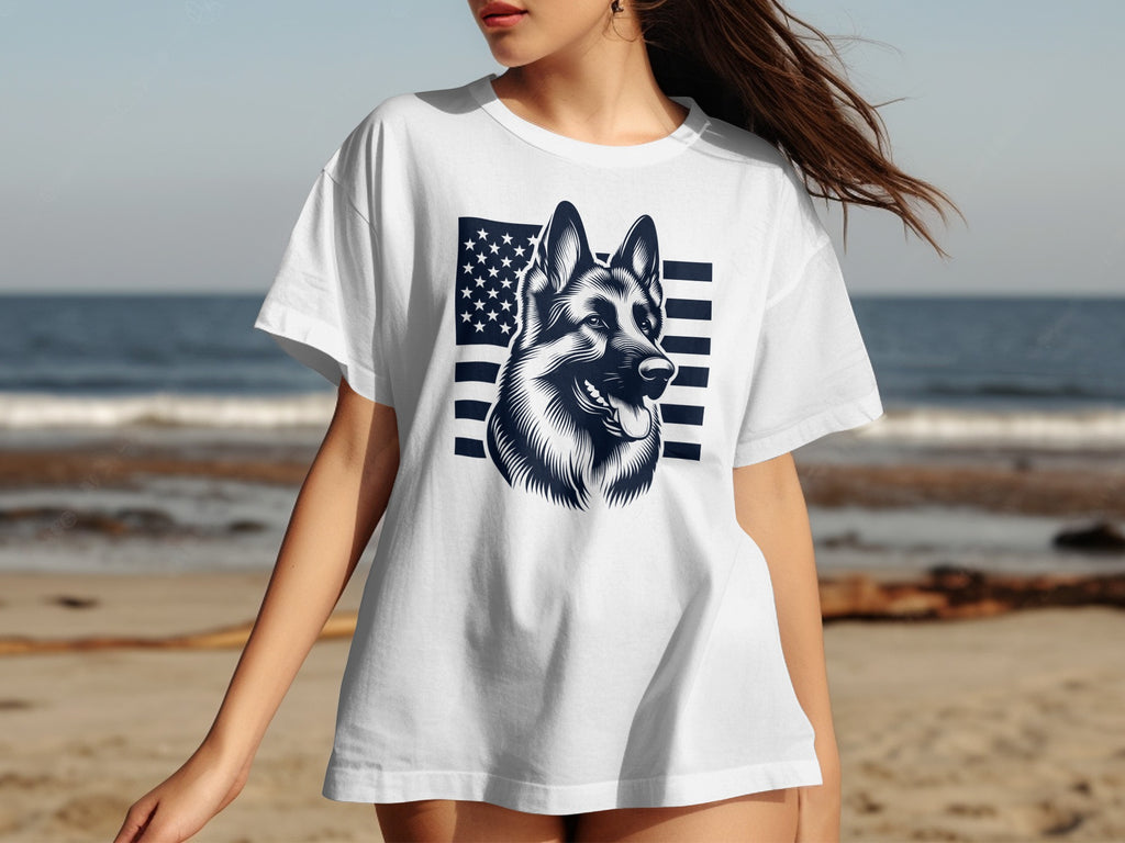 White t-shirt with German Shepherd and American flag graphic on beach background.