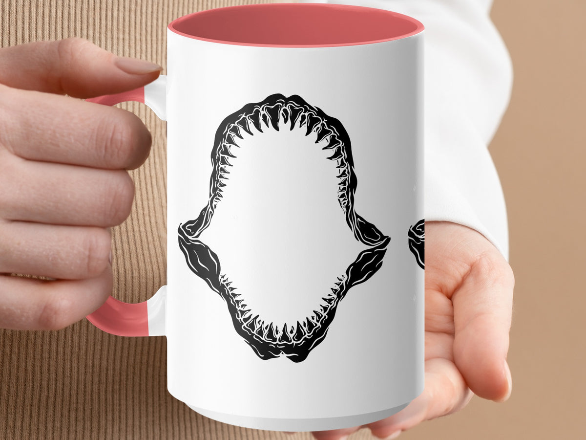 White mug with coral handle features a black shark jaw graphic.