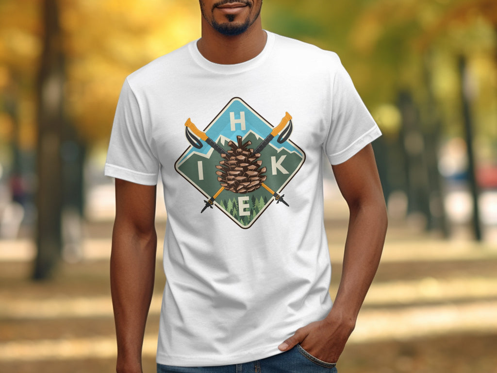 White t-shirt with a diamond graphic featuring a pinecone, mountains, poles, and the word "HIKE".
