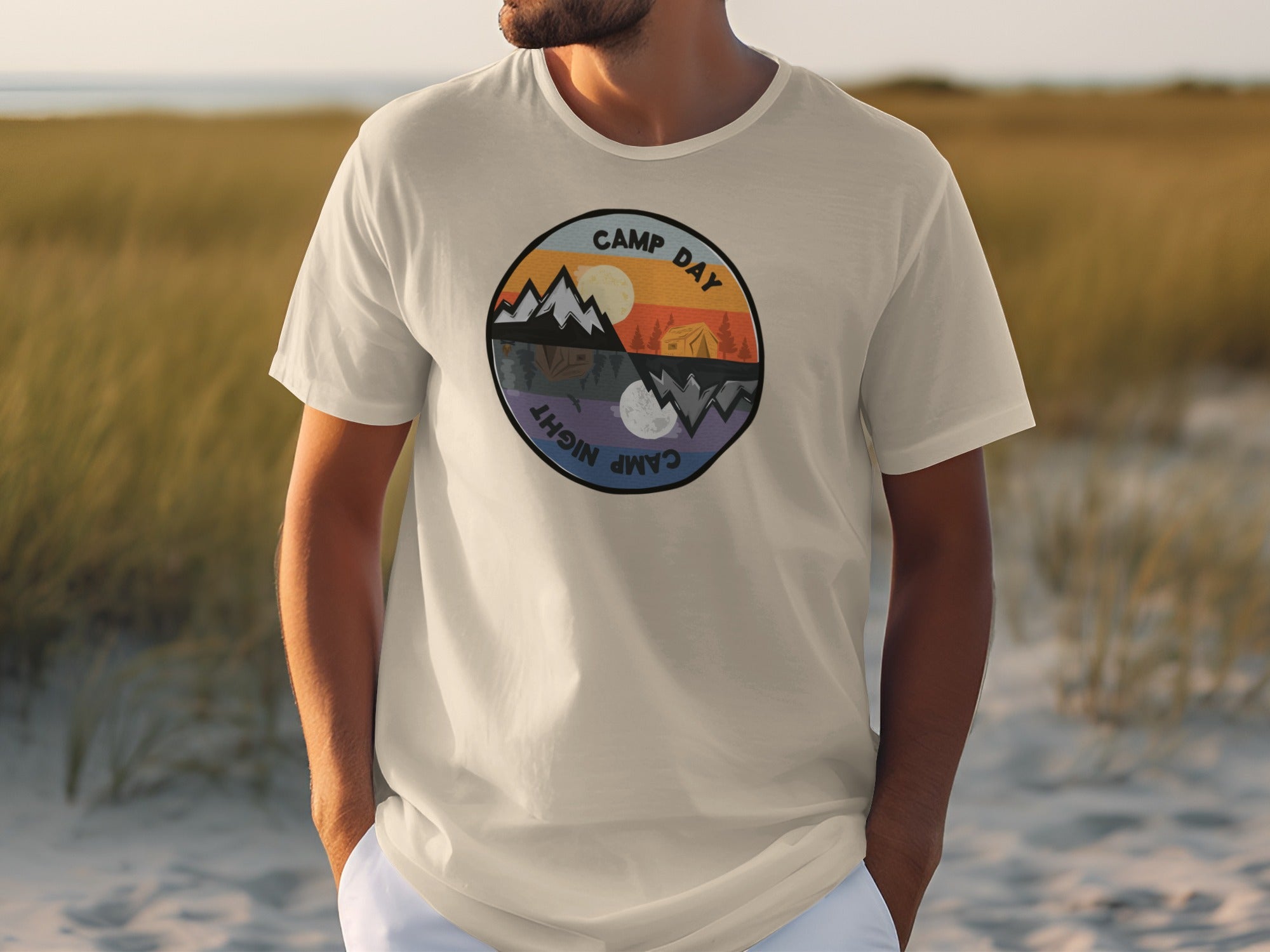 T-shirt with circular graphic showing day and night mountain camping scenes.
