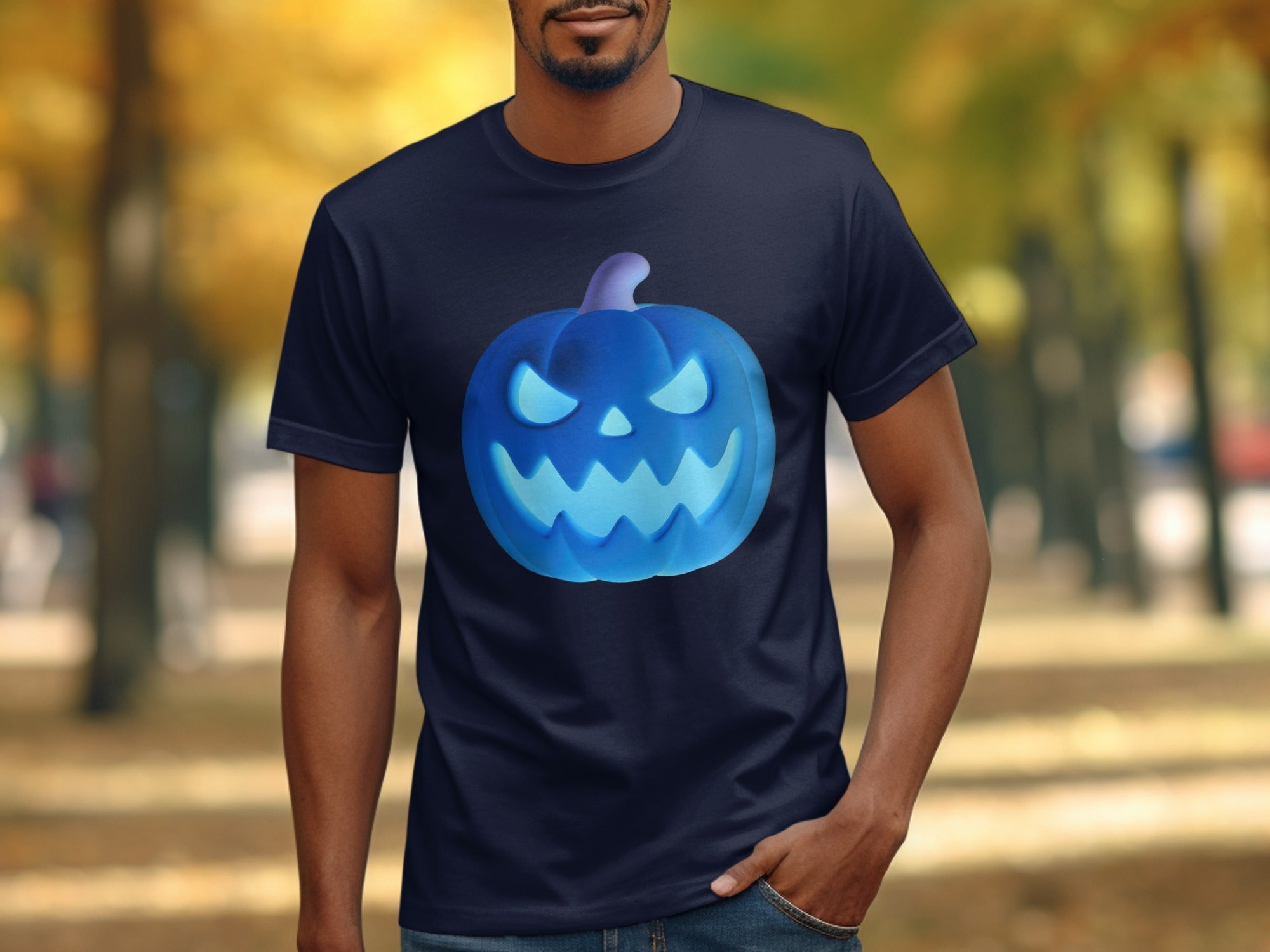 Navy t-shirt with a glowing blue jack-o'-lantern graphic on a blurred autumn background.