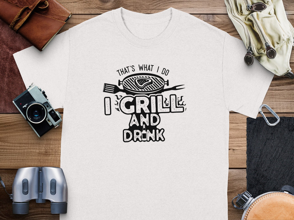 White t-shirt with black text that says "That's What I Do I Grill and Drink".