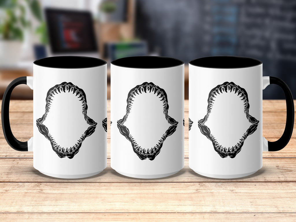 Three white mugs with black handles and interiors, featuring a black shark jaw design.