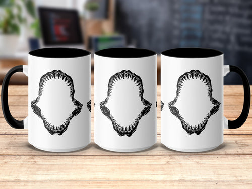 Three white mugs with black handles and interiors, featuring a black shark jaw design.