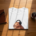 White t-shirt with a capybara wearing headphones and a headset.