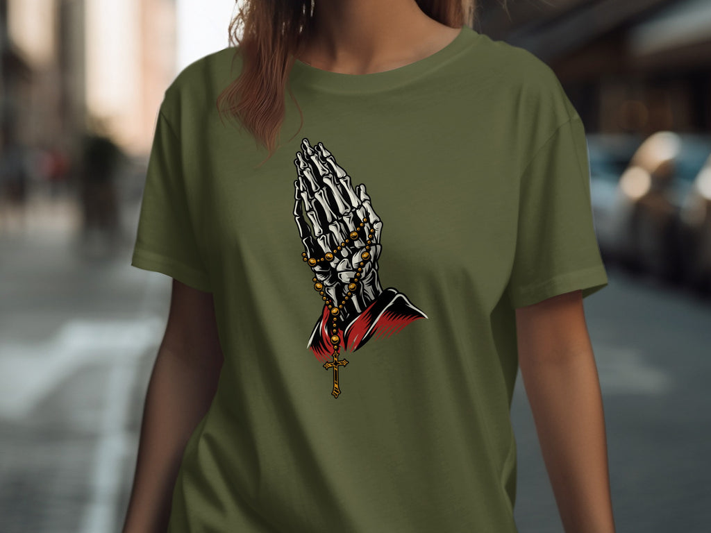 Skeleton hands praying with a rosary and crucifix on a green t-shirt.