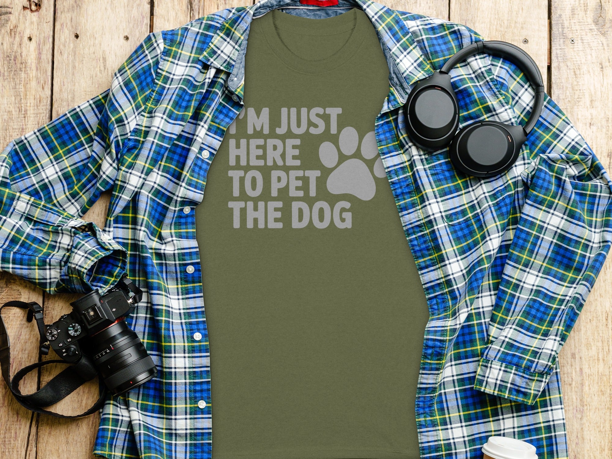 Olive green t-shirt with gray text "I'M JUST HERE TO PET THE DOG" and paw print.