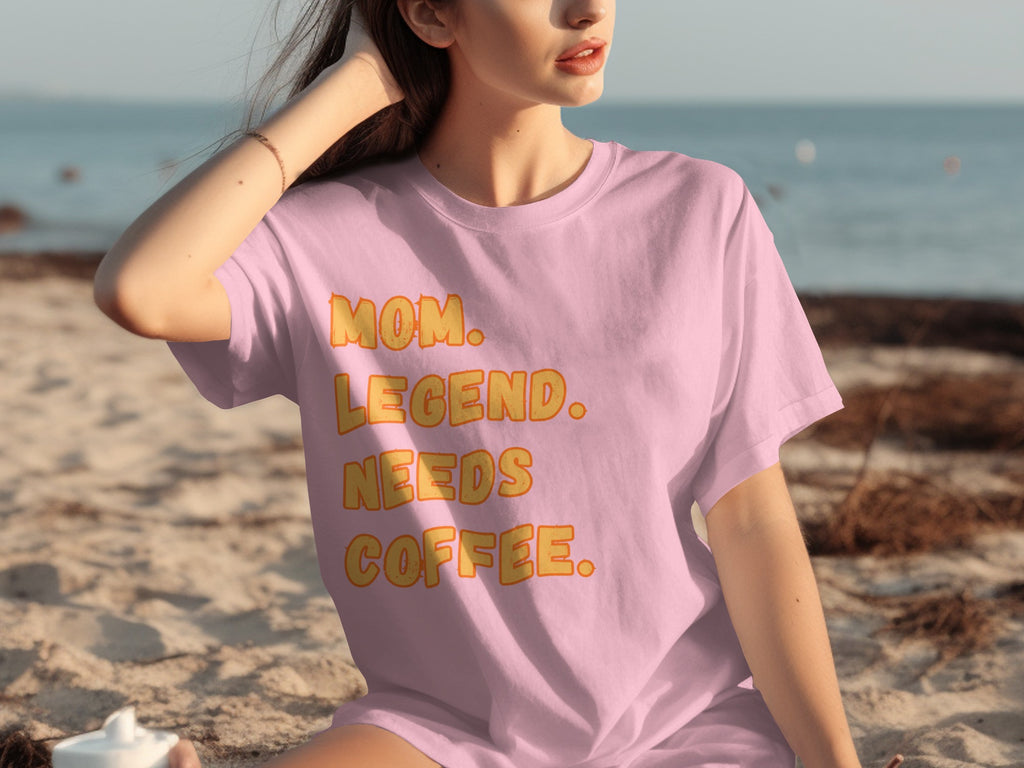 Pink t-shirt with text: Mom. Legend. Needs Coffee.